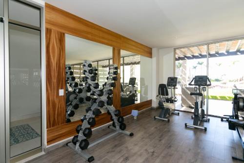 a gym with tread machines and mirrors in a house at Elemental - Vista Villa Iii in Cabo San Lucas