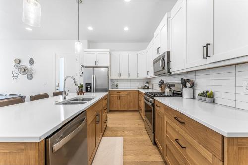 a kitchen with white appliances and wooden cabinets at Villa #18 at Bloomington Country Club townhouse in St. George