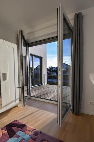 an open sliding glass door in a room with a balcony at Ferienwohnung Welfenstein in Penzing