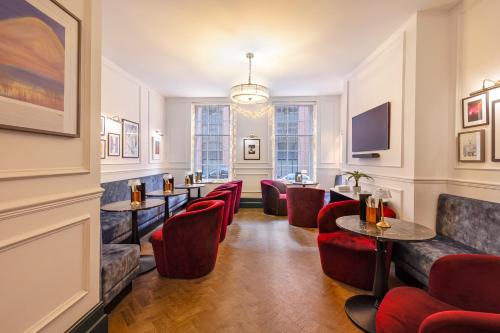 a bar with red chairs and tables in a room at Lock and Key Boutique Hotel - Duke Street in Liverpool
