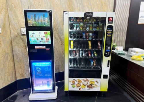 a drink vending machine with a tablet next to it at Beautiful Partition Room in Barsha heights in Dubai