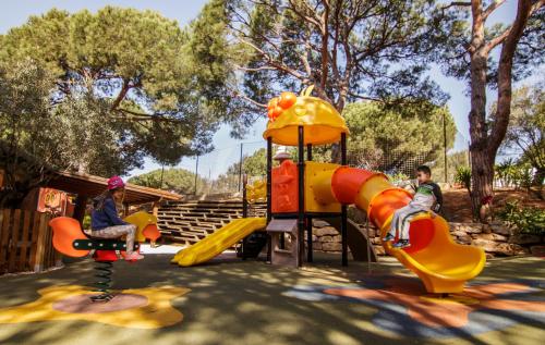 a boy and a girl playing on a playground at Complejo Turístico & Camping Cabopino in Marbella