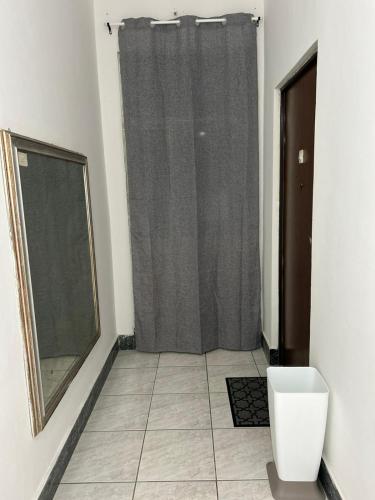 a bathroom with a shower with a toilet and a mirror at My Suite Fiuggi in Fiuggi