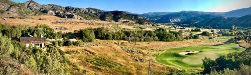an aerial view of a golf course in the mountains at GrayRock in Eagle
