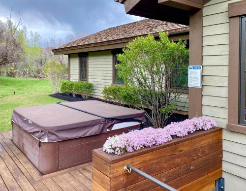 a bed on a porch of a house with flowers at GrayRock in Eagle