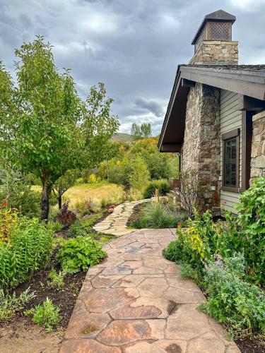 a stone walkway leading to a house with a building at GrayRock in Eagle