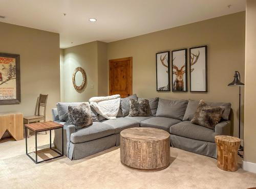 a living room with a gray couch and a table at GrayRock in Eagle
