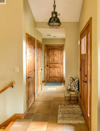 a hallway with a wooden door and a chair at GrayRock in Eagle