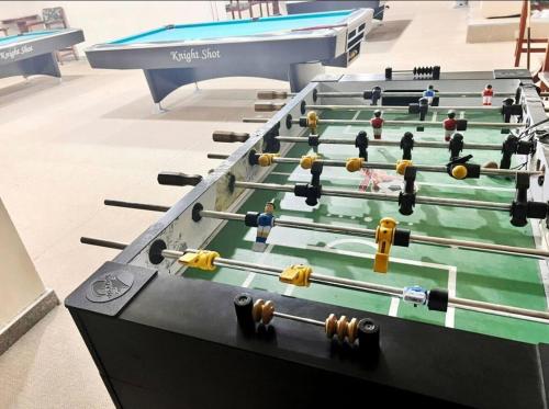 a row of ping pong tables in a room at Attraction Partition Room in Barsha heights Tecom in Dubai