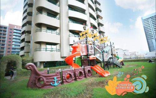 a playground in front of a tall building at Attraction Partition Room in Barsha heights Tecom in Dubai