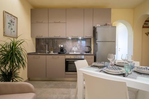 a kitchen with a table and a refrigerator at Casina Rossa in Peccioli