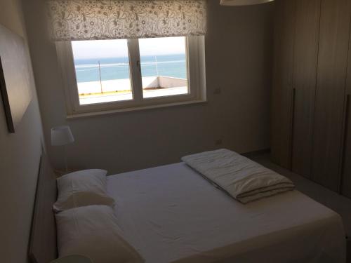 Postel nebo postele na pokoji v ubytování Appartamenti Stella Del Mare
