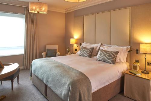 a hotel room with a large bed and a desk at The Milner York in York