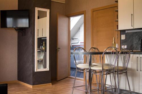 a kitchen with a table and chairs in a room at Romance in Ventspils