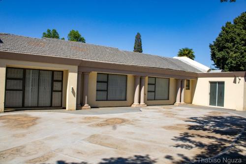 a house with a large driveway in front of it at Khayalethu in Kempton Park