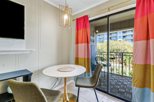 a room with a table and chairs and a balcony at Ocean Views Retreat to Ocean Dunes Villa in Hilton Head Island