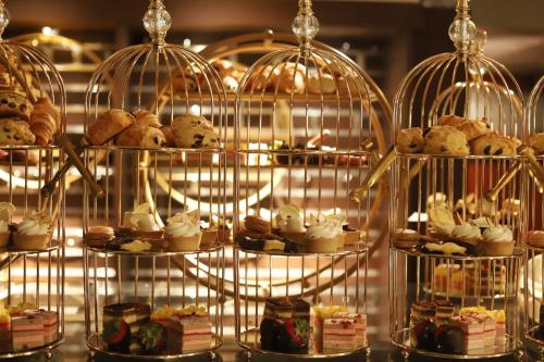 a display of bird cages filled with different types of desserts at Loews Nashville Hotel at Vanderbilt Plaza in Nashville