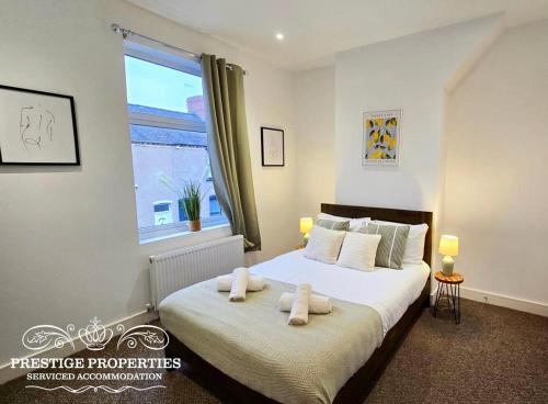 a bedroom with a bed with towels on it at 38 Gloucester street by Prestige Properties SA in Barrow in Furness