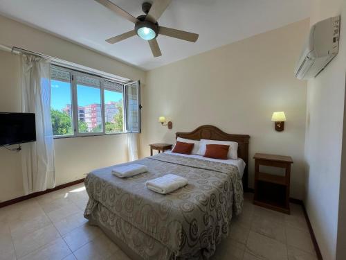 a bedroom with a bed with two towels on it at Hotel Carmen in San Bernardo