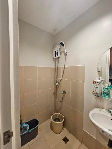 a bathroom with a shower with a sink and a toilet at The Loop 2203 - Goff's Place in Cagayan de Oro