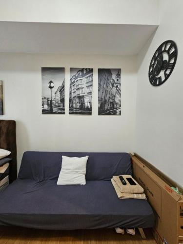 a bed in a room with four pictures on the wall at The Loop 2203 - Goff's Place in Cagayan de Oro