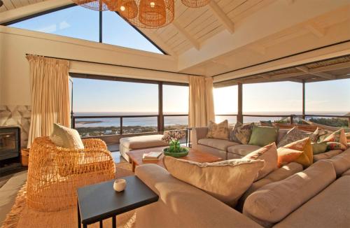 a living room with a large couch and a large window at Sunset Villa in Scarborough