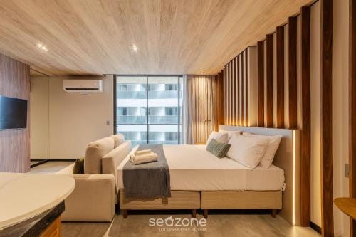 Giường trong phòng chung tại NWTs - Estúdios com Vista Lateral Mar em Maceió II