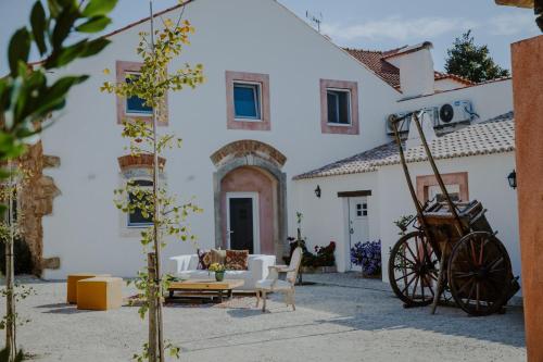 a large white building with chairs and a table at Aba da Serra - Turismo Rural in Abrigada