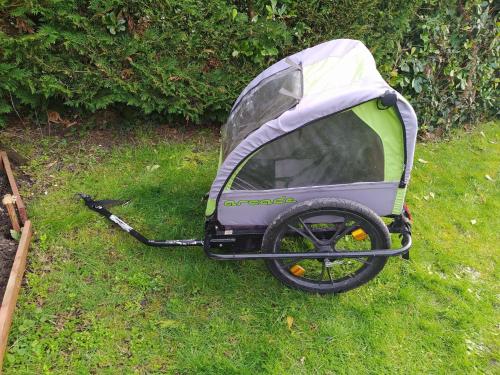 a purple and green stroller sitting in the grass at Mobilhome de Lucie et Julien in Les Mathes