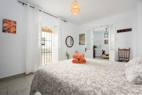 a bedroom with a bed with a stuffed animal on it at La Casa De Eva in Gaucín