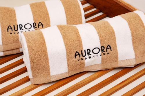 two towels sitting on top of a bed at Aurora in Unawatuna