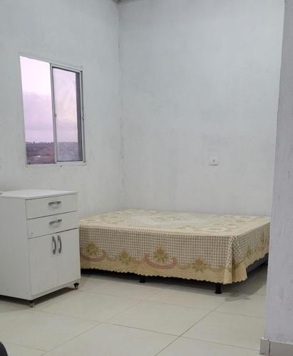a white room with a bed and a window at Marina's in Pau dʼAlho