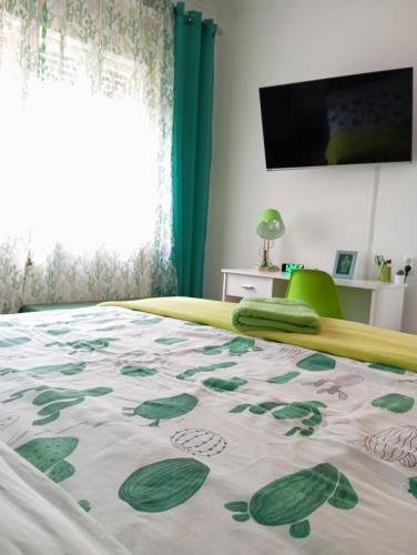 a bedroom with a bed with a green and white carpet at Green Cactus Rooms - unique and cozy house in Senta