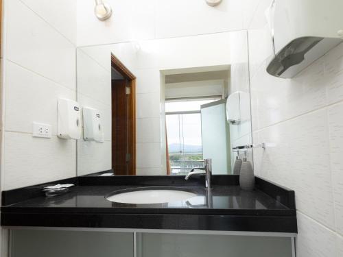 a bathroom with a sink and a mirror at Hotel San Marino Tarapoto in Tarapoto