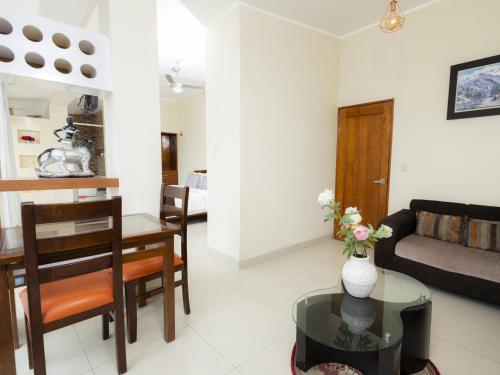 a living room with a table and a couch at Hotel San Marino Tarapoto in Tarapoto
