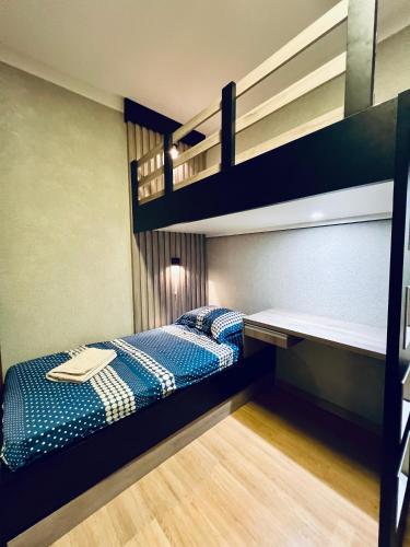 two bunk beds in a small room with a bed at Moderno Sobrado Climatizado com Ar Quente e Frio in Cascavel