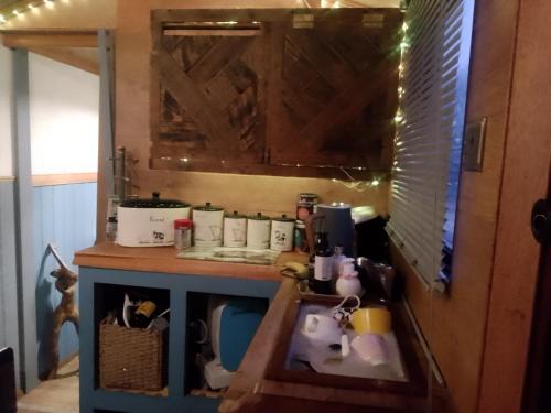 a kitchen with a counter with a sink and a counter top at The Stables in Gloucestershire