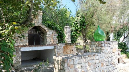 a stone fireplace with a vase on top of it at Santa Lucia-Park Coppa della Nuvola in Peschici