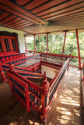 a room with red benches in a building at Finca Hotel in Armenia