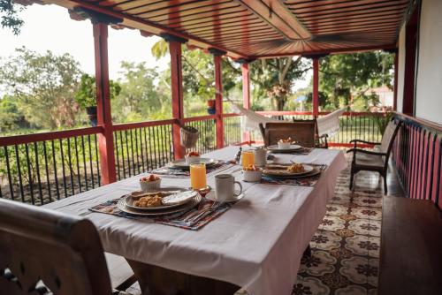 a table with plates of food on a porch at Finca Hotel in Armenia