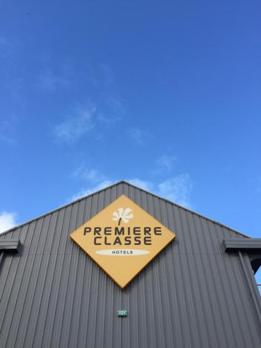 a yellow sign on top of a building at Premiere Classe Saint Malo St Jouan Des Guerets in Saint-Jouan-des-Guérets