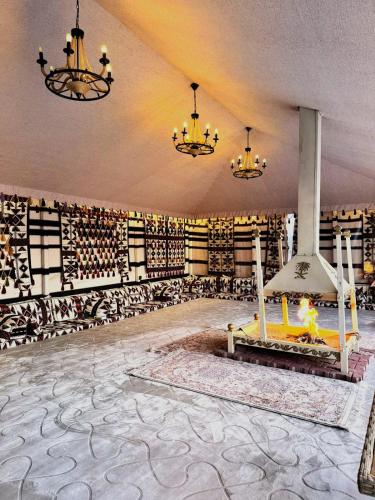 a large room with a wall of wine bottles at Golden Sayf AlUla in AlUla