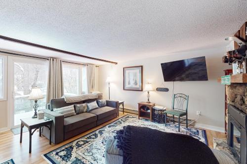 a living room with a couch and a tv at Easy Street Retreat in Sugar Mountain