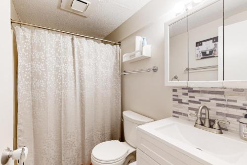 une salle de bain avec un rideau de douche et des toilettes dans l'établissement Easy Street Retreat, à Sugar Mountain
