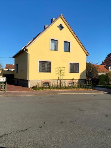 a yellow house on the side of a street at Kleine Auszeit in Bad Driburg