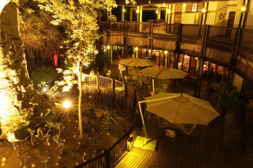 an overhead view of a patio with umbrellas at night at Cresta Mowana Safari Resort & Spa in Kasane