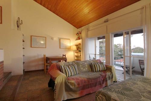 a living room with a couch and a table at Apartamento Vizir in Vila Nova de Milfontes