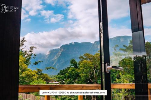 a door with a view of the mountains at Pousada Vale dos Balões in Praia Grande