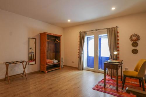 a living room with a table and a window at Casa Muru By Wynwood House in Cusco
