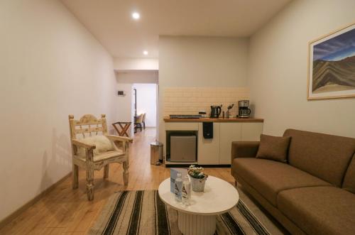 a living room with a couch and a table at Casa Muru By Wynwood House in Cusco